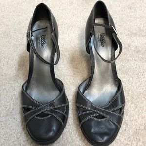 Black leather heels with white stitching